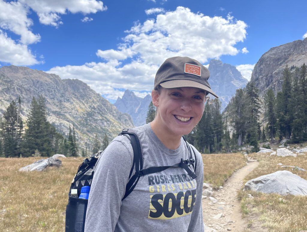 Liz Haley '23 in Grand Teton National Park on a trail with mountains behind her