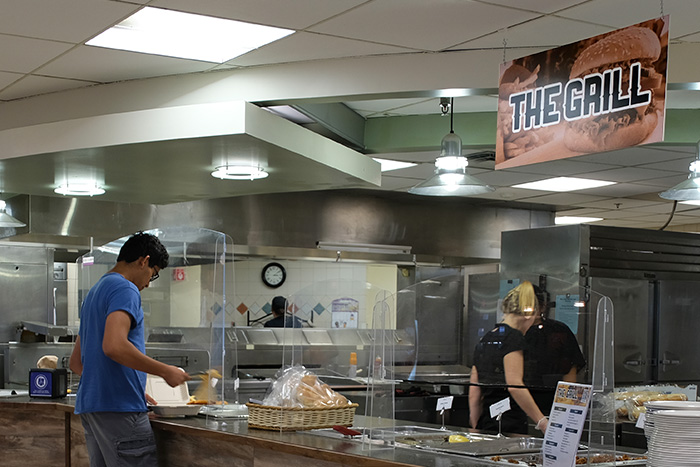 Student getting food at The Grill station in Mary Jemison Dining Complex.