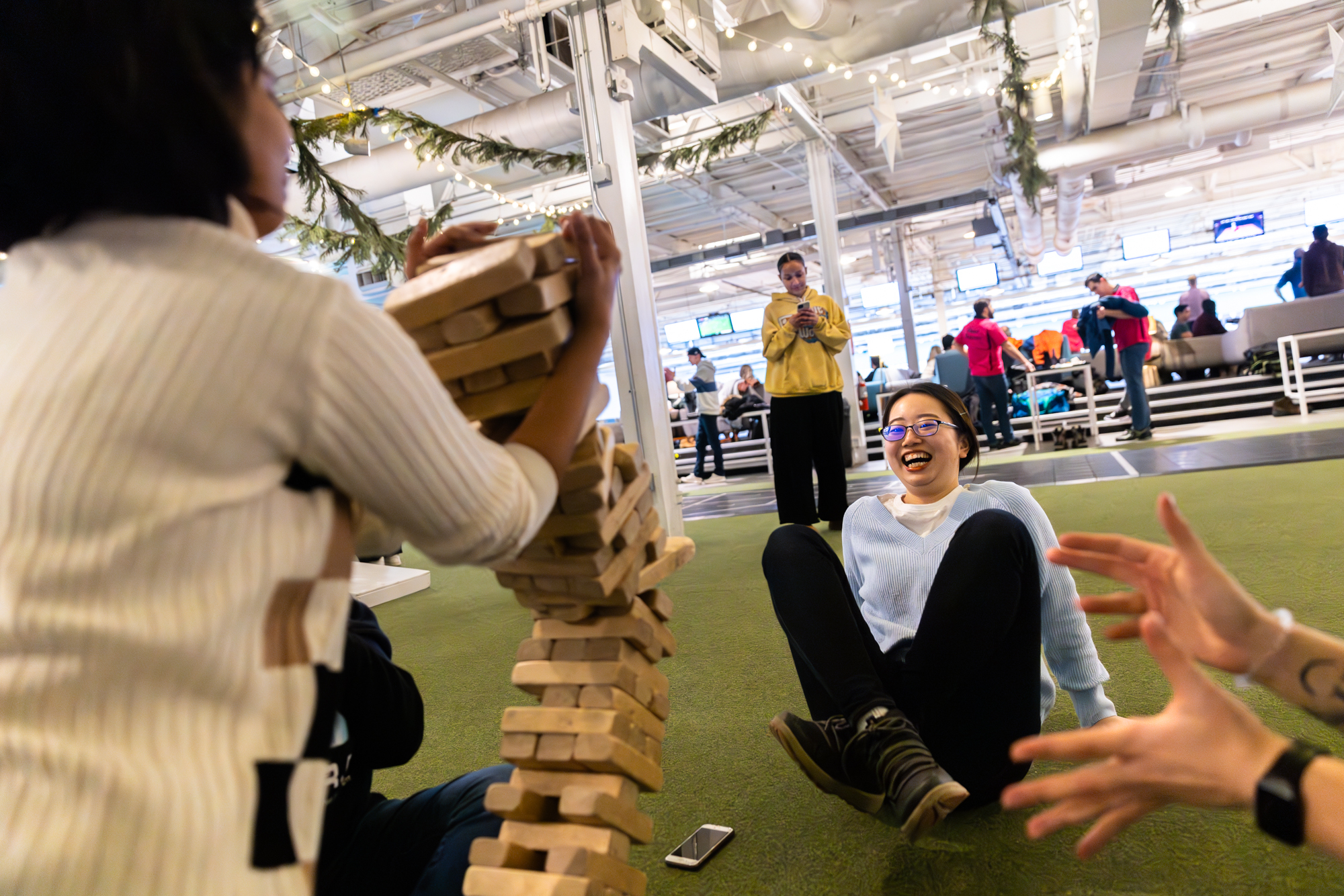 Three students playing Jenga together