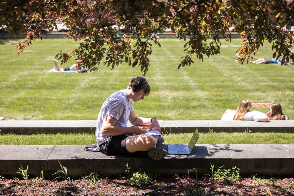 student studying on green
