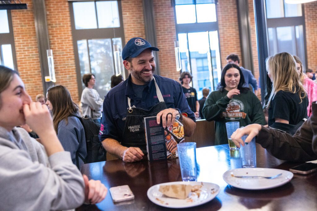 Matt Abdoo '02 talks with students during a dinner service on campus.
