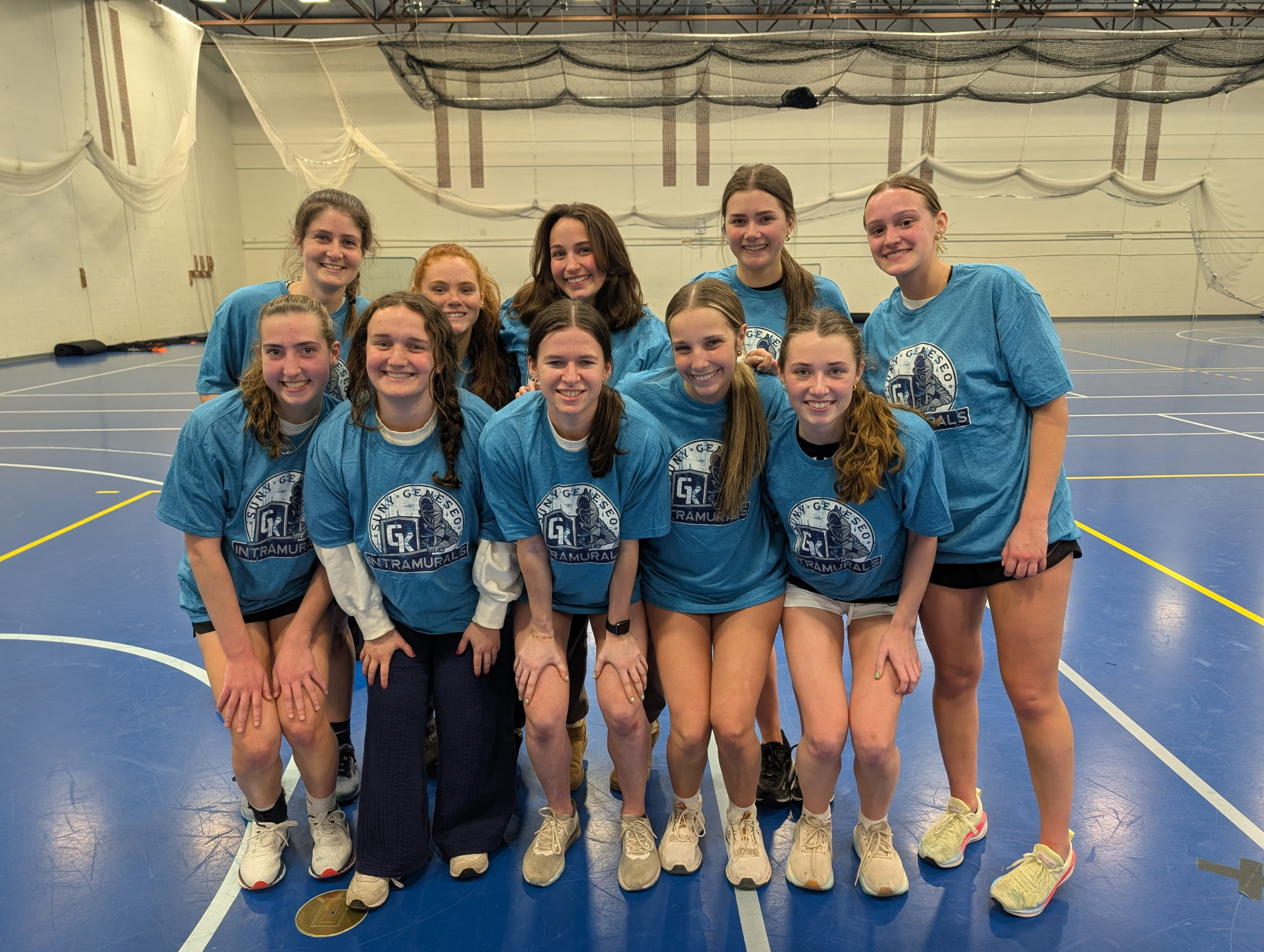 group of students together, in kuhl gym, wearing blue intramural shirts