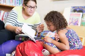 Adult teaching child to read