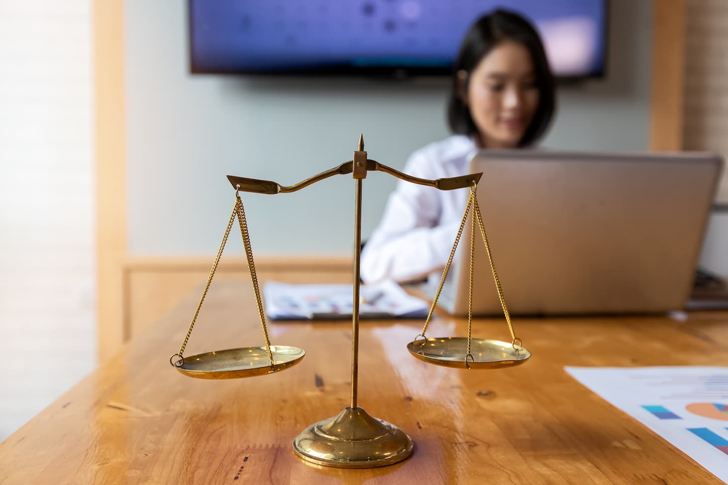 Law student studying with scale in foreground