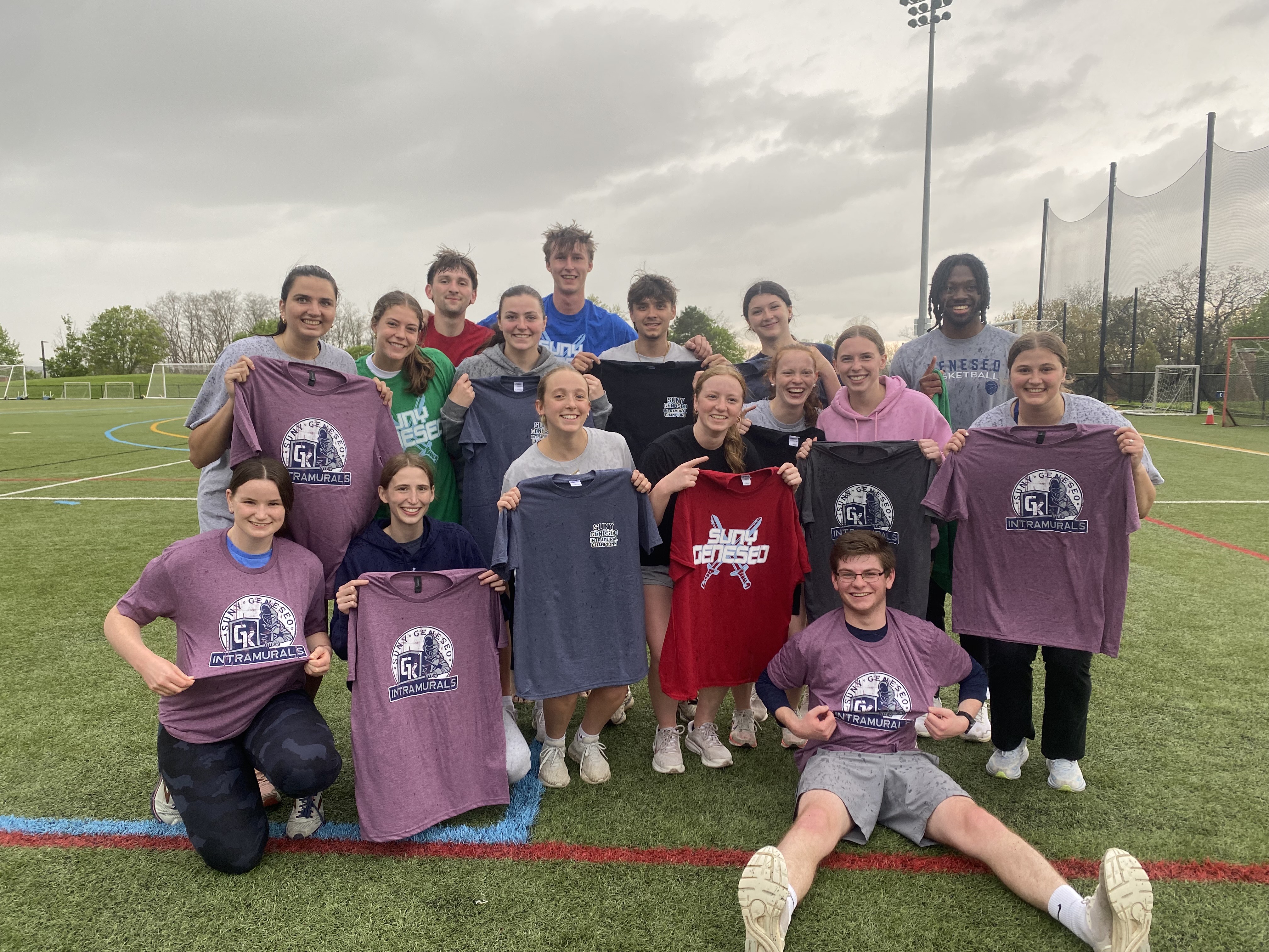 group of students outside on the turf. mix of maroon champ shirt and grey shirts