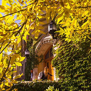 Student walking into Welles Hall