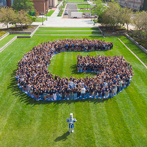 Students forming letter G