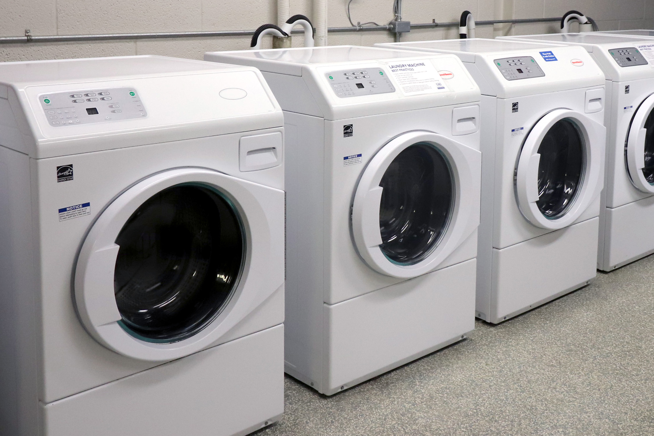 Row of energy efficient front-loading washing machines.