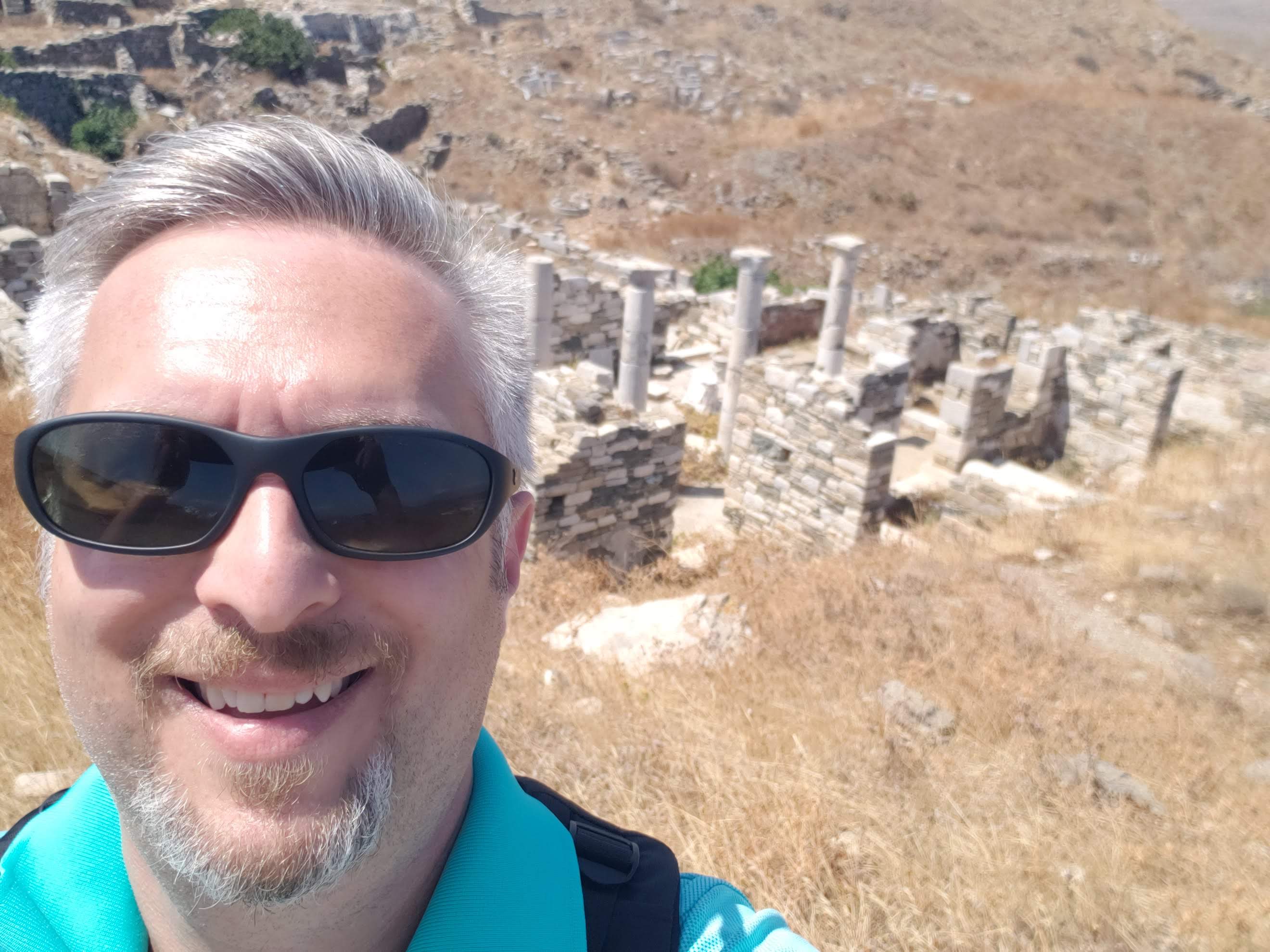 David Levy in front of ancient stone ruins with columns, suggesting an arid archaeological site.