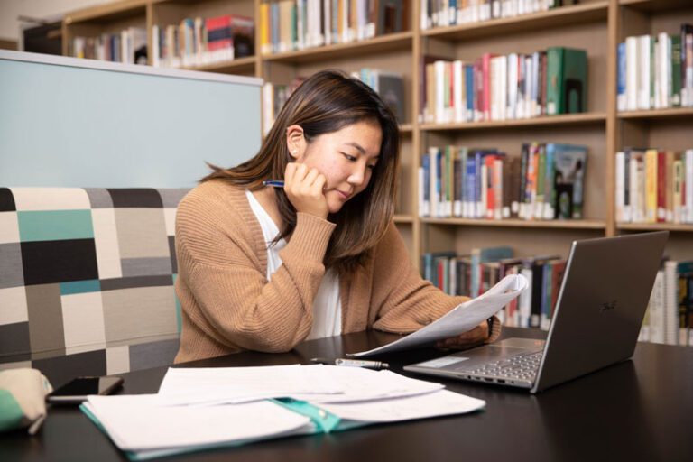 Student-by-bookshelves-WEB