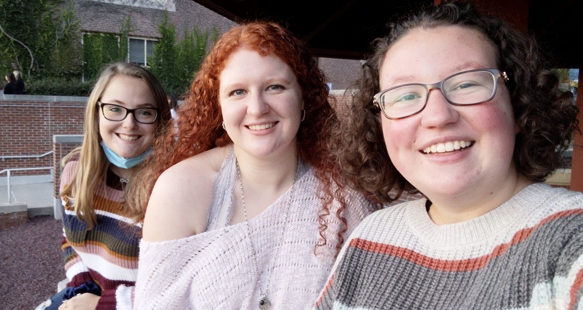 Three students watch the sunset 