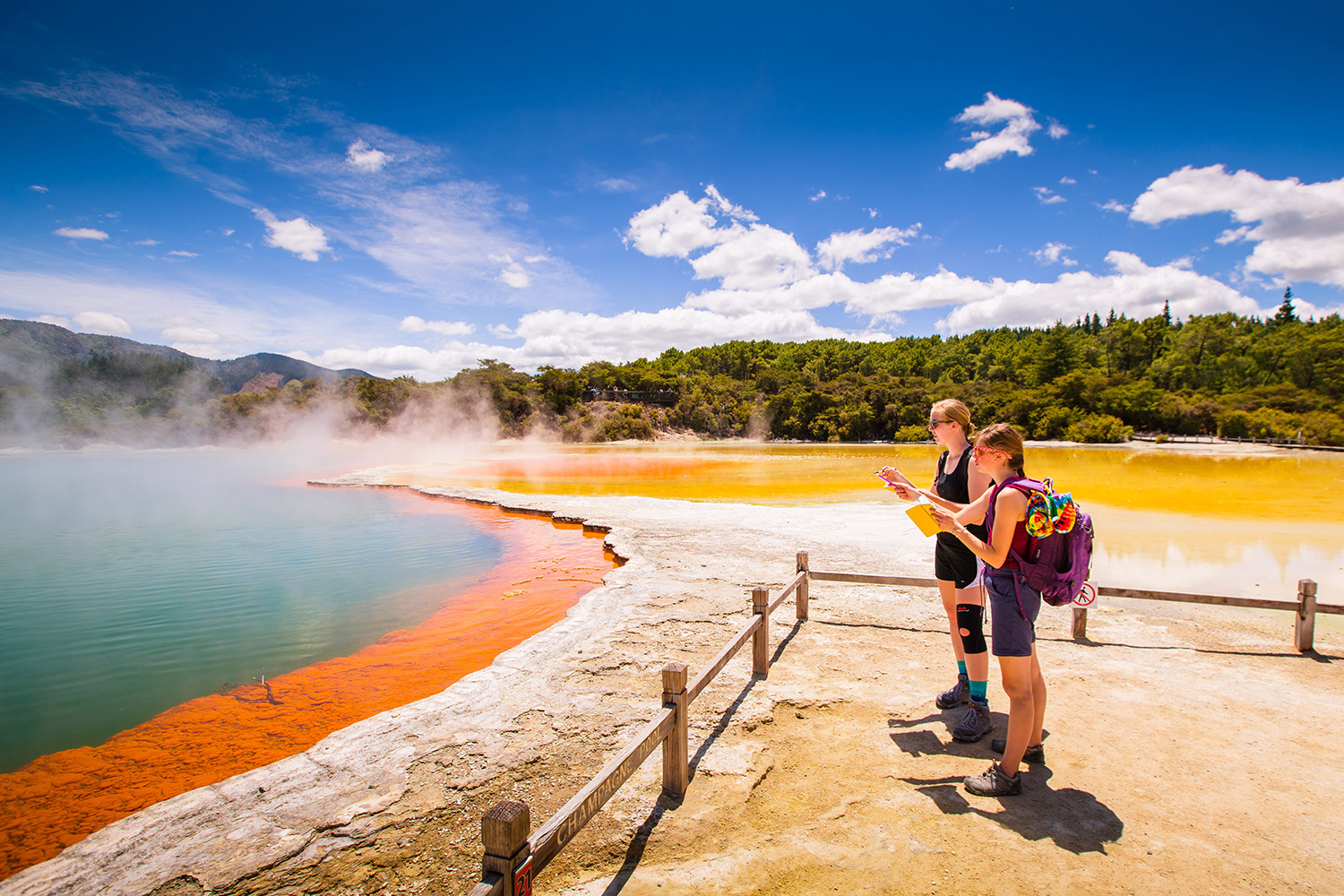 Two students look at the themal pools in New Zealand