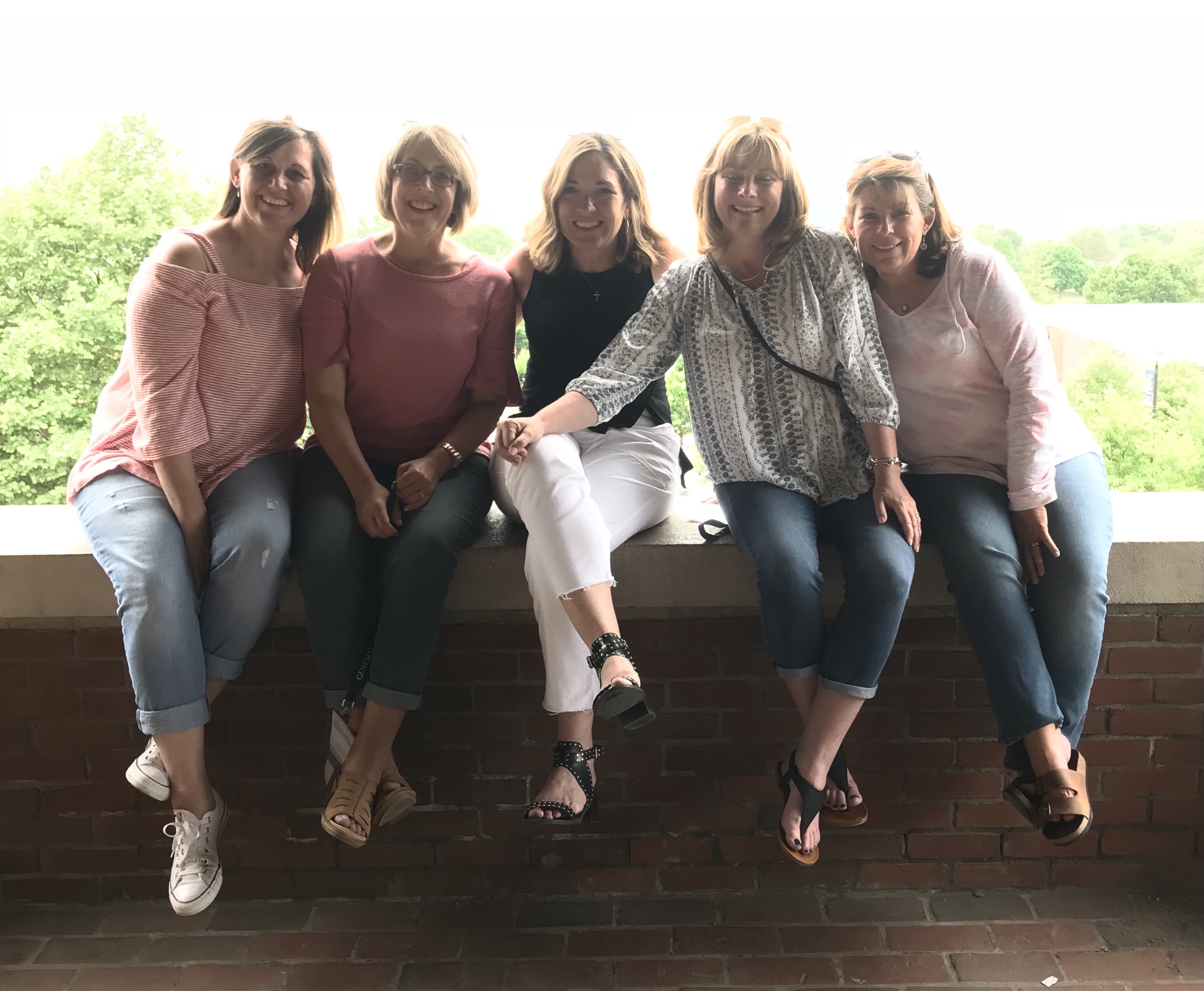 Sarah Grammatico and four of her friends sit on the gazebo wall