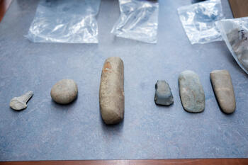 Items believed to have been used 3700–3000 Before Present. From left to right: a drill, a net sinker for fishing, a pestle, and three wedges. (SUNY Geneseo/Matt Burkhartt)
