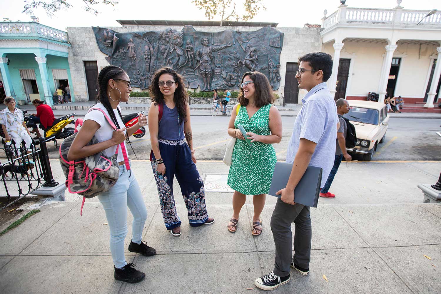 A professor speaks with students in Cuba.