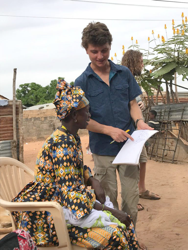 Declan Dwyer-McNulty '17 in the Gambia talking to a woman