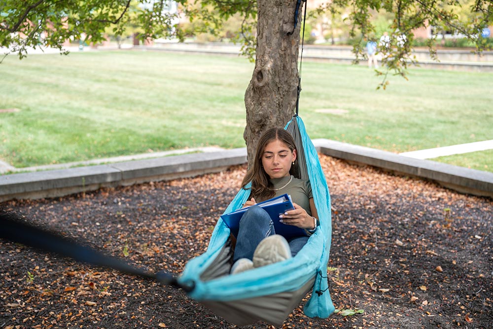 Student studying in hammock