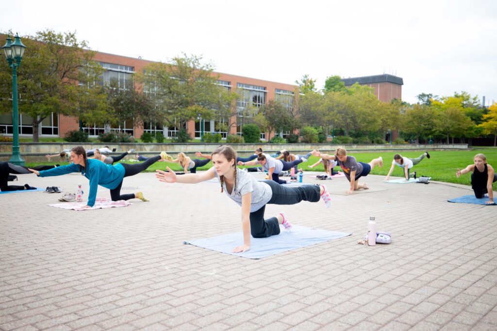Student Yoga Class A photo of students doing yoga on the upper quad in front of the Integrated Science Center.
