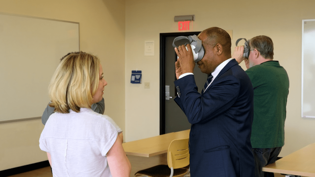 Professor showcasing virtual goggles