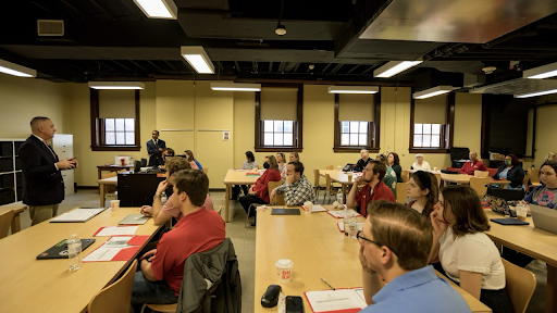 Teacher speaking to large classromm