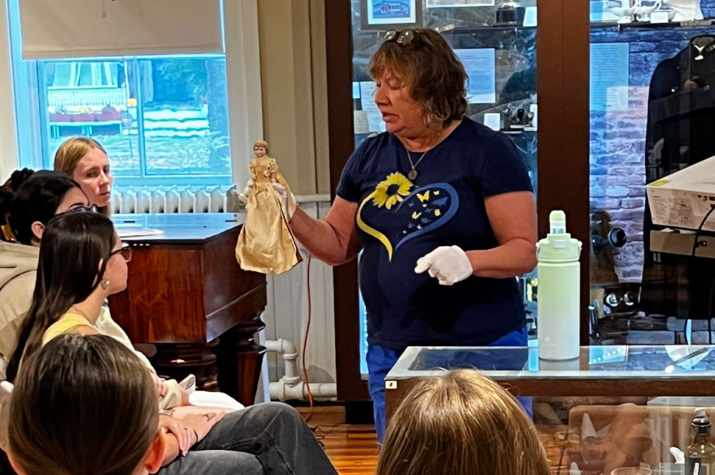 Teacher showing object to students