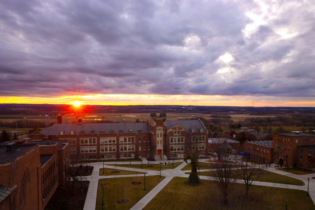A view of the Geneseo campus at sunset, facing Sturges Hall and the valley.