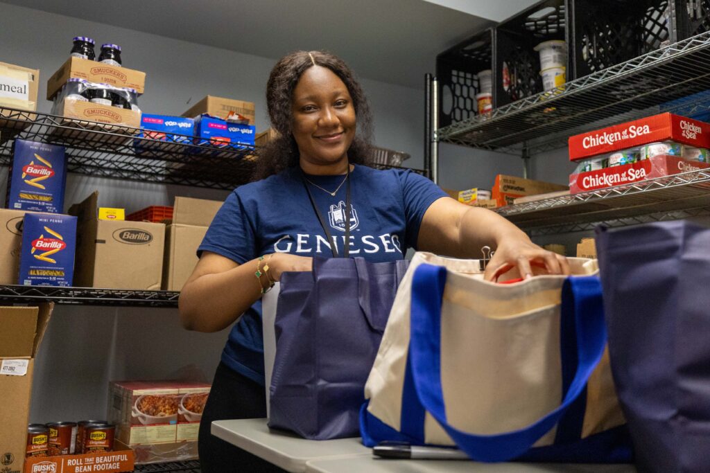 Wilhelmina Maame Takyi ’28 packs bags of food for fellow students in the Knights Harvest Pantry.