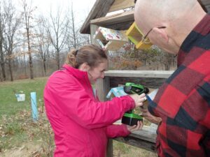 Alli Menendez ('21) installing bee boxes in the Arboretum's "Bee Barn" in April 2019.