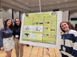 Sophia Stang ('26), Carly Wick ('25), and Julia Lingenfelter ('25) presenting their poster at GREAT Day 2025.
