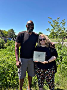 Multicultural Affairs Director Cliff Harcum and WGSU Director Kelli Sperino-Pease with the 2026 Earth Day Celebration plaque