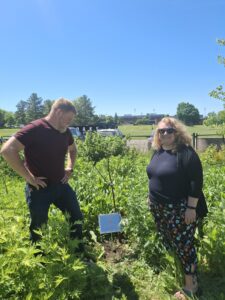 Dan Dezarn, Applied Learning Specialist with the SUNY Geneseo Sustainabilities Program and WGSU Director Kelli Sperino-Pease with the 2026 Earth Day plaque and cherry tree