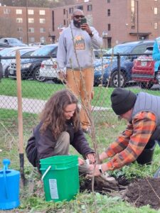 Dan Dezarn, Applied Learning Specialist with the SUNY Geneseo Sustainabilities Program and student planting the 2026 Earth Day cherry tree