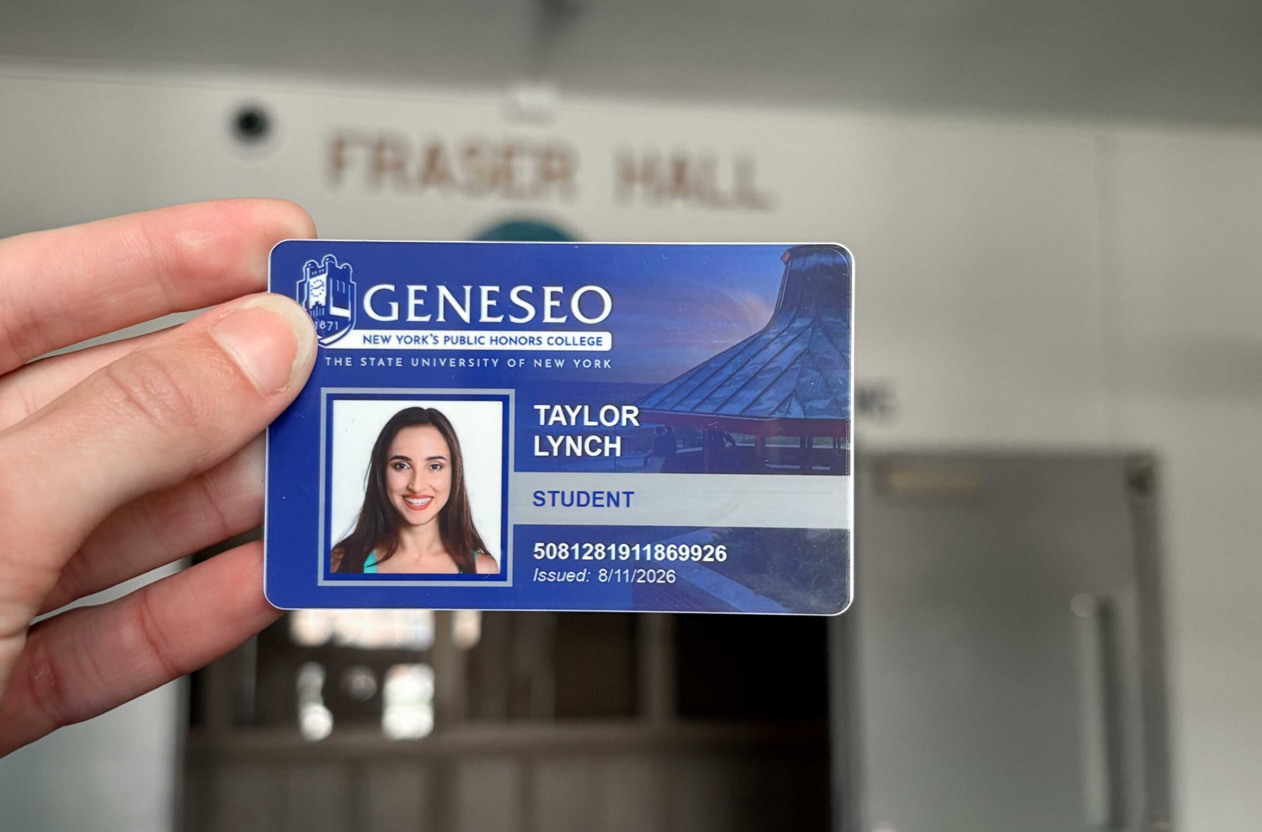 Student holding ID card in Fraser Hall